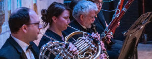 Hastings Symphony Orchestra musicians playing french horns in concert